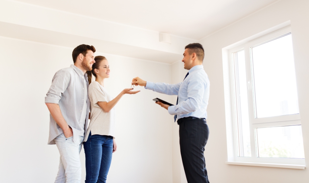 Real Estate Agent Giving Key to New Owners